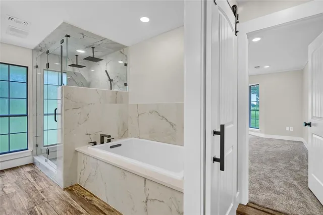 a bathroom with a bathtub and a shower