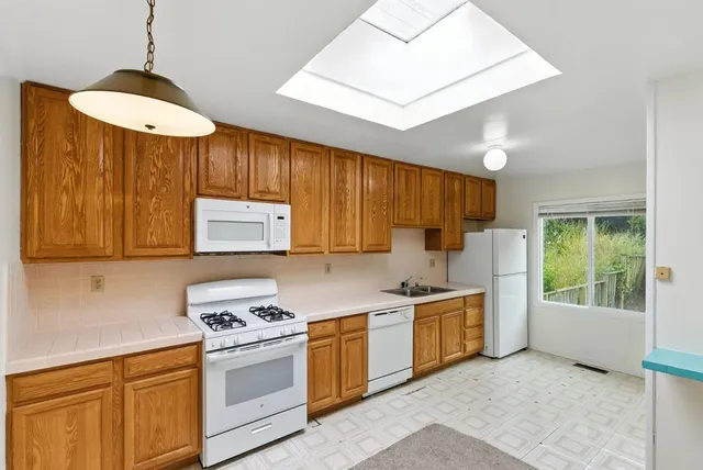 a kitchen with a stove a sink and a refrigerator