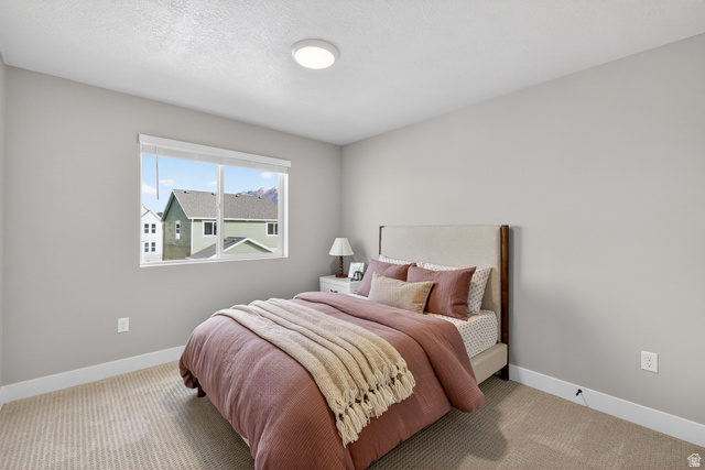 2841 West 2705 North, Unit 69 Ogden, UT 84404 - Photo 21 of 31 Spacious room featuring neutral carpeting, a large window, and light gray walls