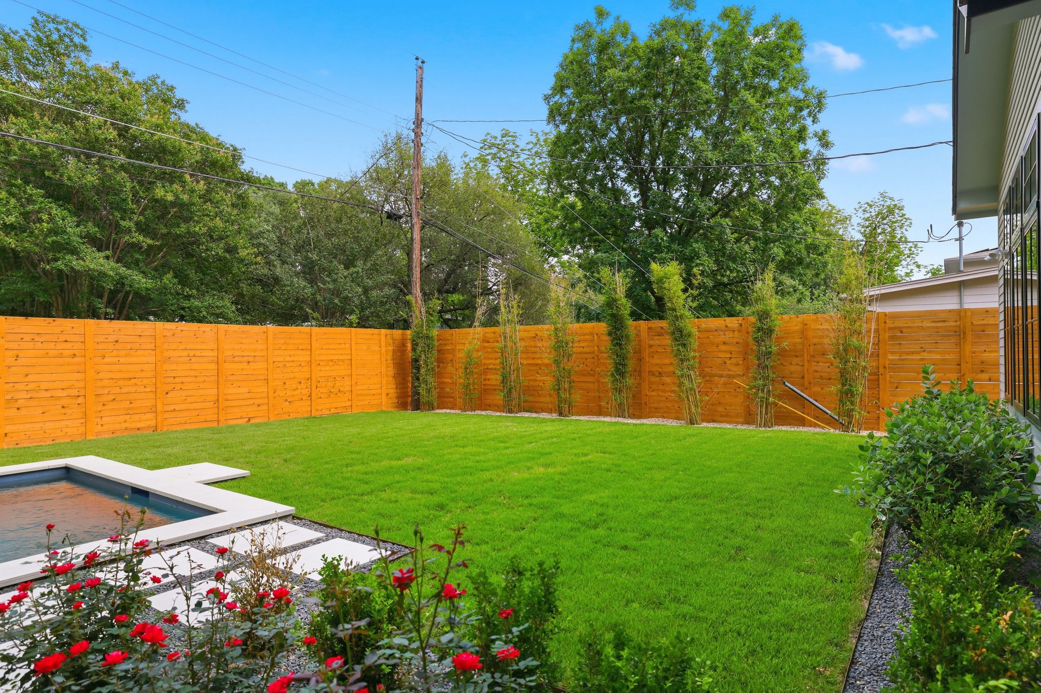 6611 Lexington Road Austin, TX 78757 - Photo 34 of 37 Expansive green lawn framed by a new wood privacy fence