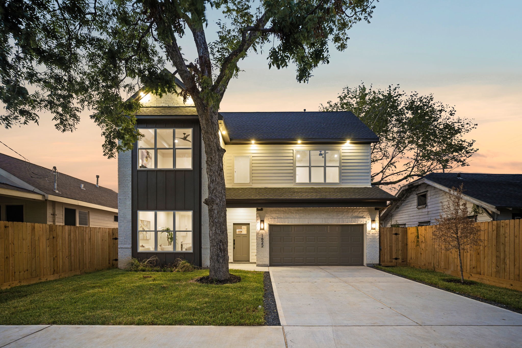 a front view of a house with a yard and garage