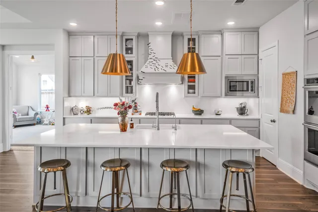 a kitchen with stainless steel appliances kitchen island a refrigerator and a sink