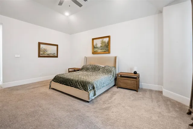 a bedroom with a bed and a wall painting