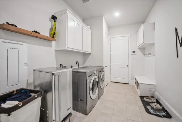 a utility room with sink dryer and washer
