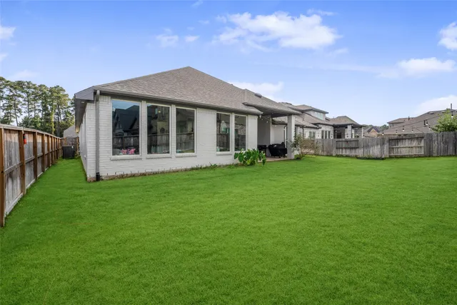 a view of a house with a yard and sitting area