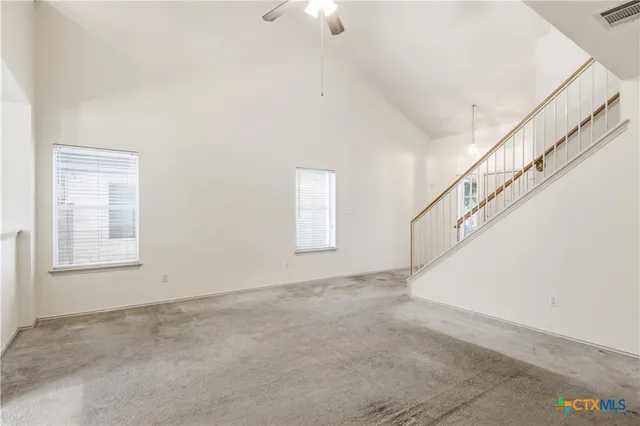 a view of an empty room with windows