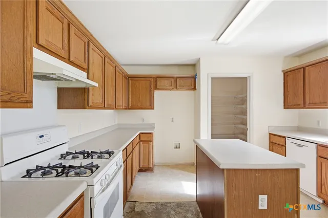 a kitchen with stainless steel appliances a stove a sink and a refrigerator