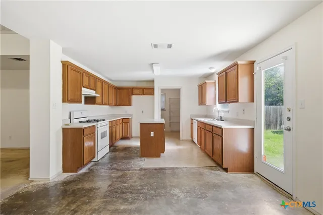 a large kitchen with a stove top oven