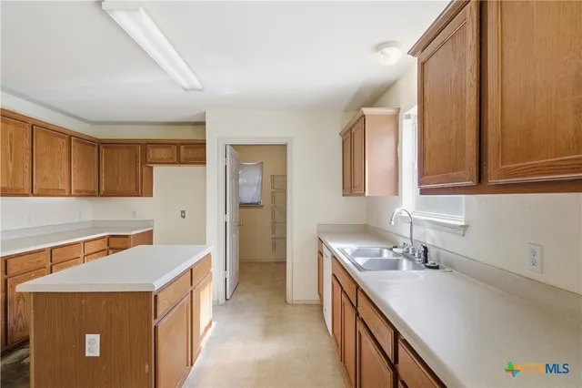 a kitchen that has a sink and a stove in it
