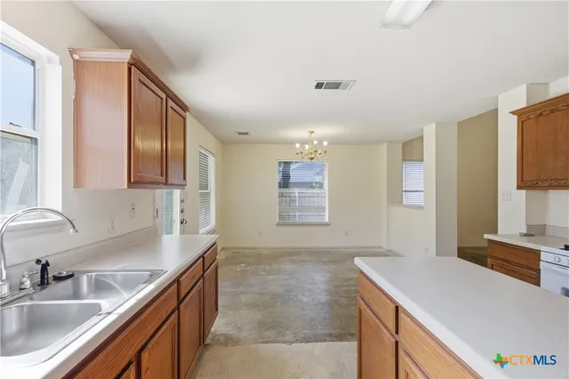 a kitchen that has a sink and a stove in it