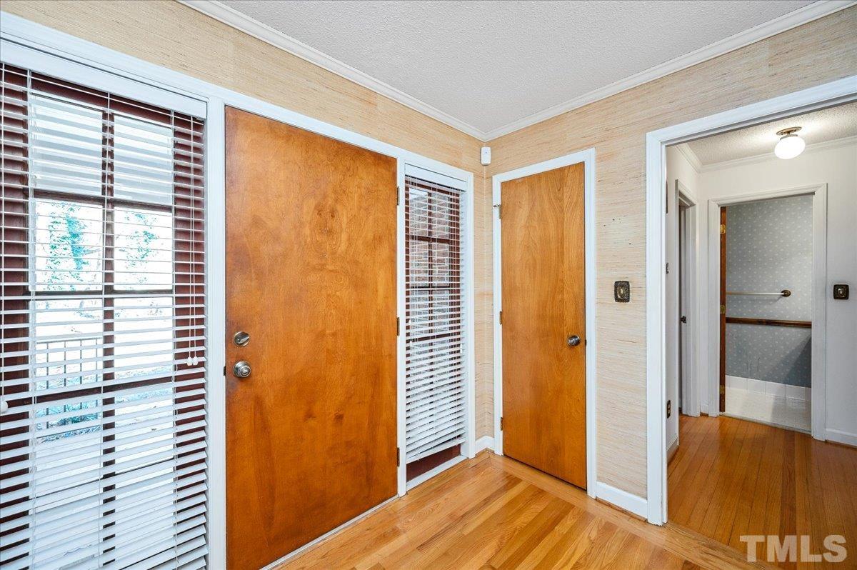 8913 Oneal Road Raleigh, NC 27613 - Photo 14 of 39 a view of a bedroom with wooden floor and a balcony