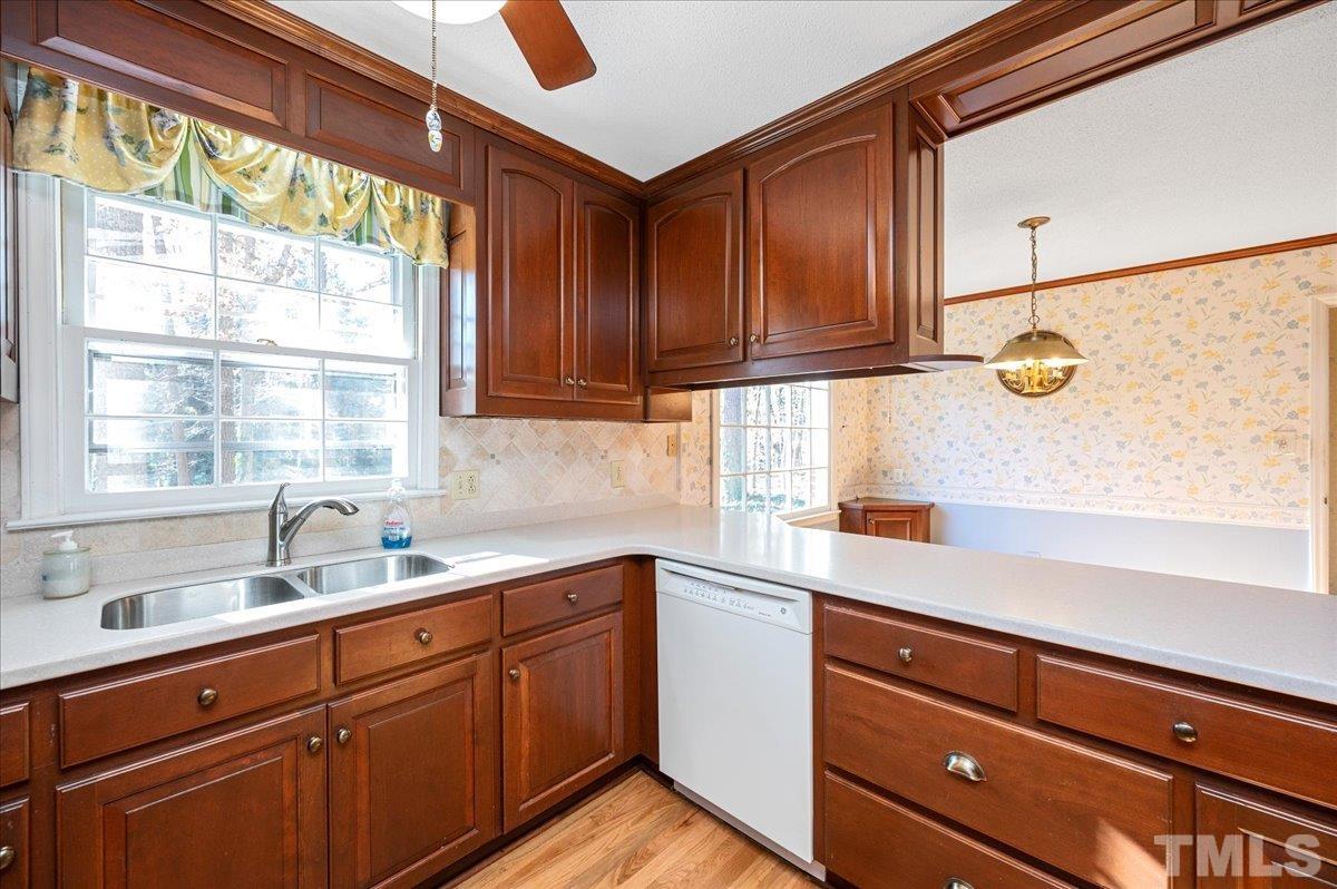 8913 Oneal Road Raleigh, NC 27613 - Photo 24 of 39 a kitchen with a sink window and cabinets