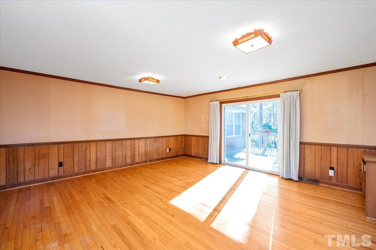 8913 Oneal Road Raleigh, NC 27613 - Photo 27 of 39 a view of an empty room with wooden floor and a window