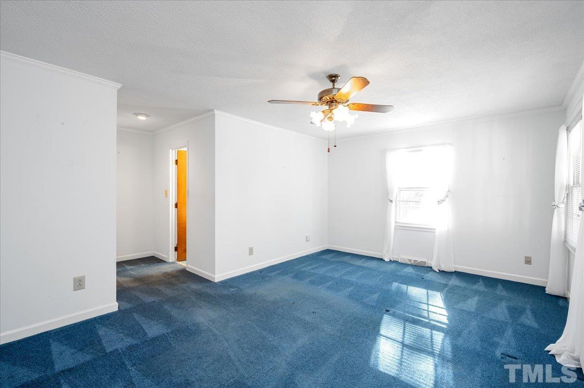 8913 Oneal Road Raleigh, NC 27613 - Photo 34 of 39 an empty room with wooden floor and natural light