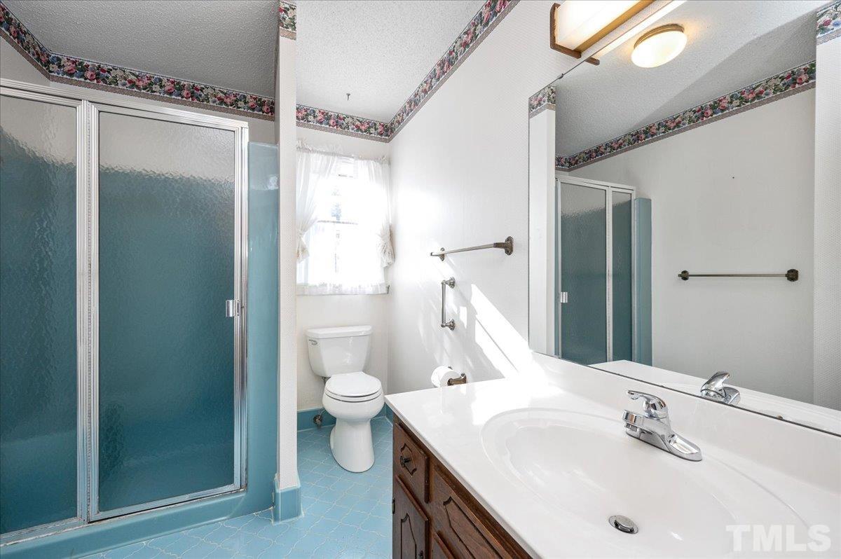 8913 Oneal Road Raleigh, NC 27613 - Photo 36 of 39 a bathroom with a sink toilet and shower