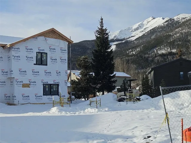 a front view of a house with a yard and seating space