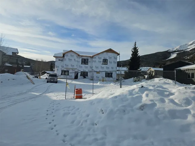 a view of a house with a snow in the yard