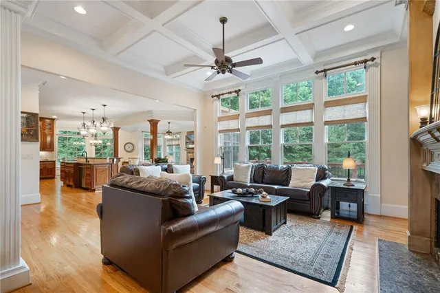 a living room with furniture a fireplace and a chandelier