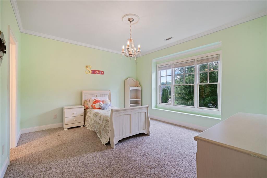 1750 Cone Flower Way Suwanee, GA 30024 - Photo 32 of 58 a living room with a baby crib furniture and a window