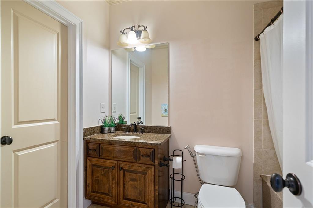 1750 Cone Flower Way Suwanee, GA 30024 - Photo 37 of 58 a bathroom with a toilet a sink and a mirror
