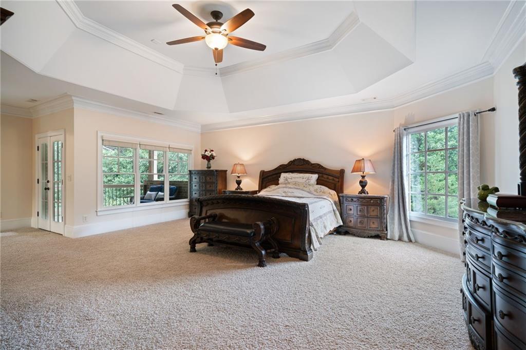 1750 Cone Flower Way Suwanee, GA 30024 - Photo 38 of 58 a bedroom with a bed and a chandelier