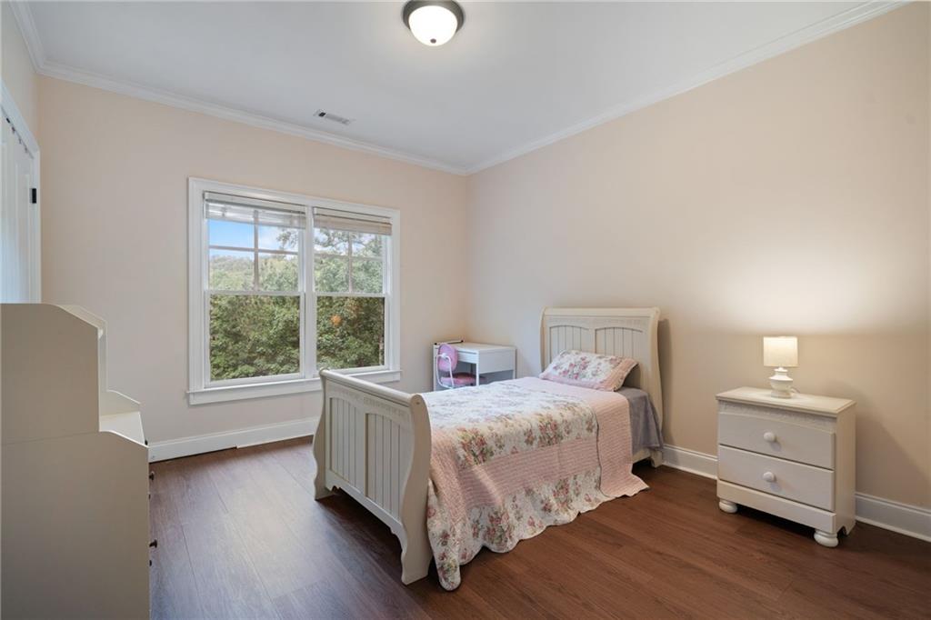 1750 Cone Flower Way Suwanee, GA 30024 - Photo 41 of 58 a bedroom with a bed and a large window
