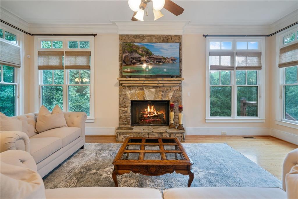 1750 Cone Flower Way Suwanee, GA 30024 - Photo 43 of 58 a living room with furniture a window and a fireplace