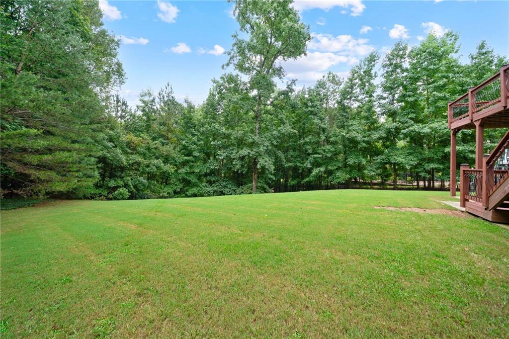 1750 Cone Flower Way Suwanee, GA 30024 - Photo 52 of 58 a view of a field of grass and trees