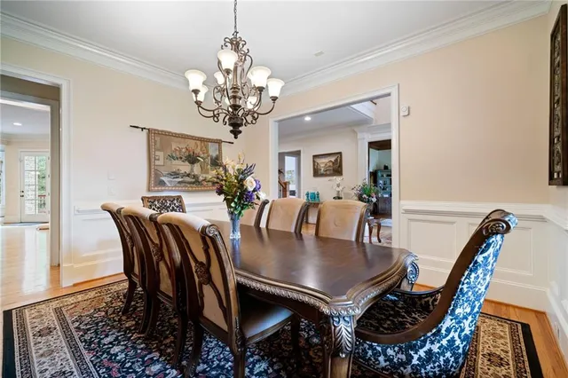 a view of a dining room with furniture and chandelier