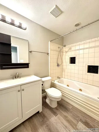 a bathroom with a sink toilet a mirror and shower