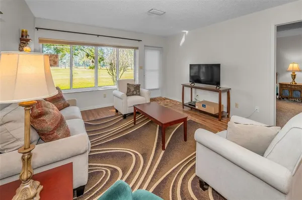 a kitchen with stainless steel appliances sink a stove and white cabinets