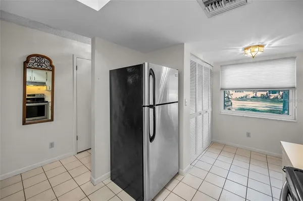 a bedroom with a bed a lamp and a window