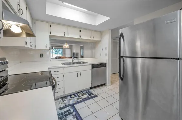 a bedroom with a bed and a lamp on dresser