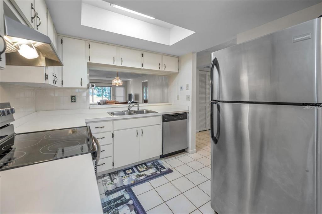 3521 Teeside Drive New Port Richey, FL 34655 - Photo 22 of 73 a kitchen with stainless steel appliances a refrigerator sink and cabinets