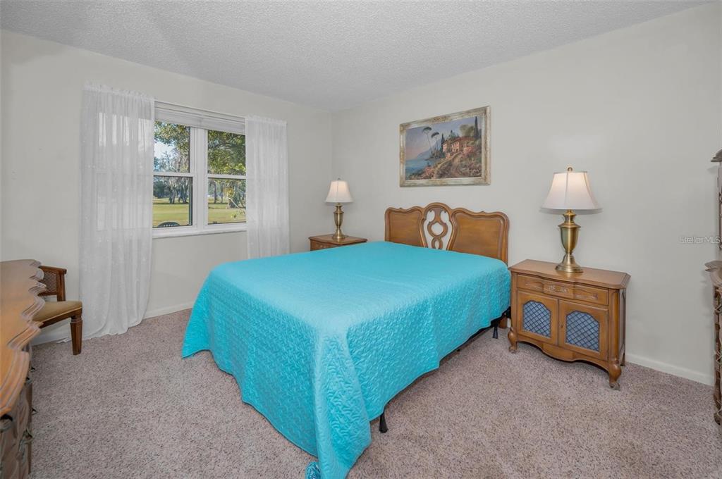 3521 Teeside Drive New Port Richey, FL 34655 - Photo 25 of 73 a bedroom with a bed a lamp and a window