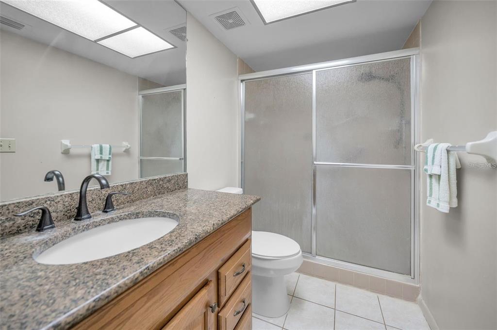 3521 Teeside Drive New Port Richey, FL 34655 - Photo 28 of 73 a bathroom with a granite countertop sink toilet and shower