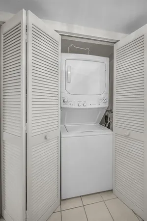 a view of a hallway with closet and a couch