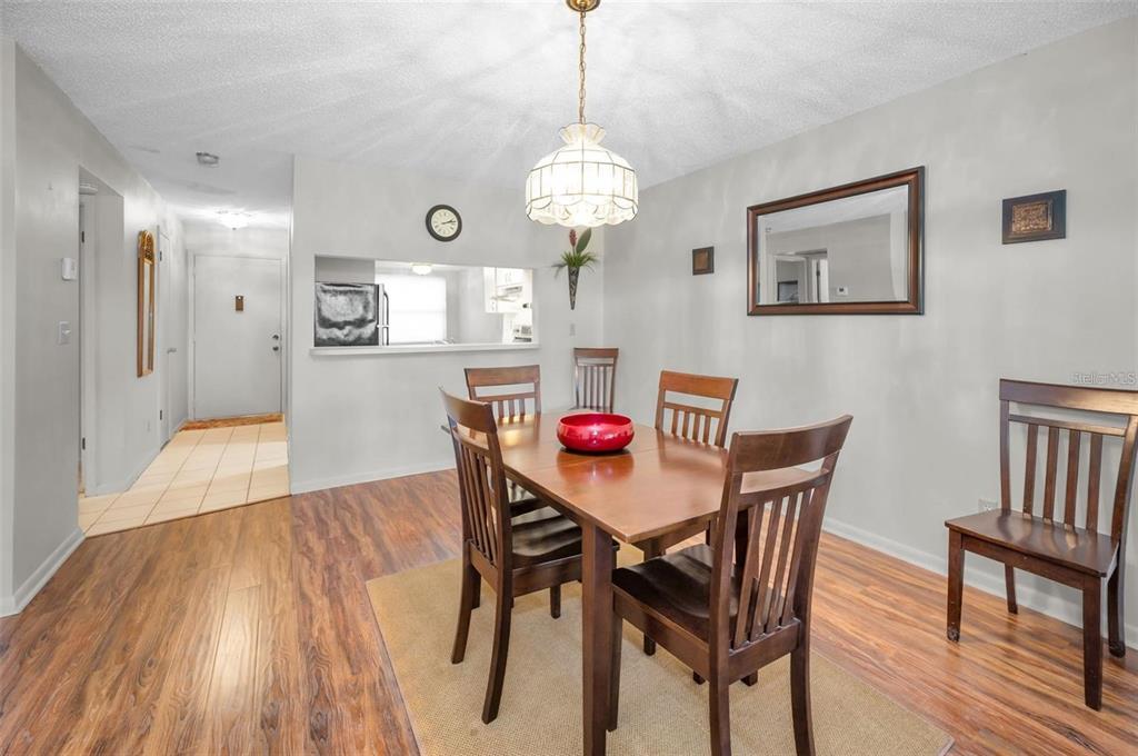 3521 Teeside Drive New Port Richey, FL 34655 - Photo 9 of 73 a dining room with wooden floor a chandelier a wooden table and chairs