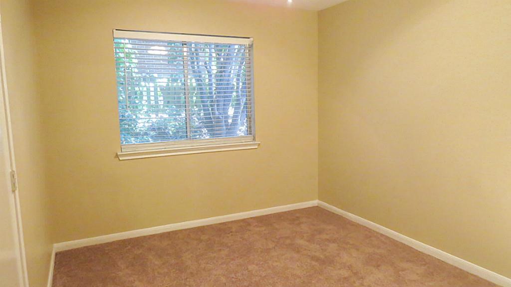 10926 Waterview Circle Montgomery, TX 77356 - Photo 12 of 15 The second bedroom has a ceiling fan, a view of tress, and a side garden. This is perfect for nature lovers.