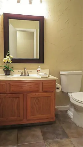 a bathroom with a toilet a sink and mirror