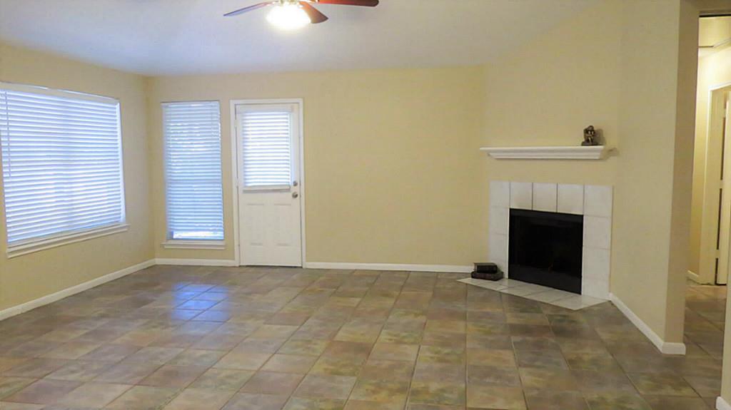 10926 Waterview Circle Montgomery, TX 77356 - Photo 3 of 15 Cozy up to your fireplace in the winter or enjoy the ceiling fans and cold A/C in the summers. The all tile living room welcomes your guests every season.