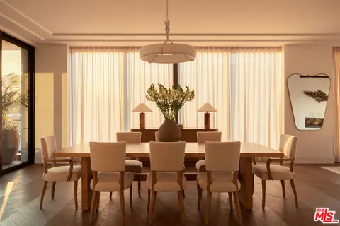 a kitchen with a sink chairs and white appliances