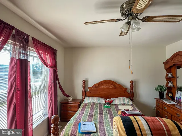 a bedroom with a bed and ceiling fan