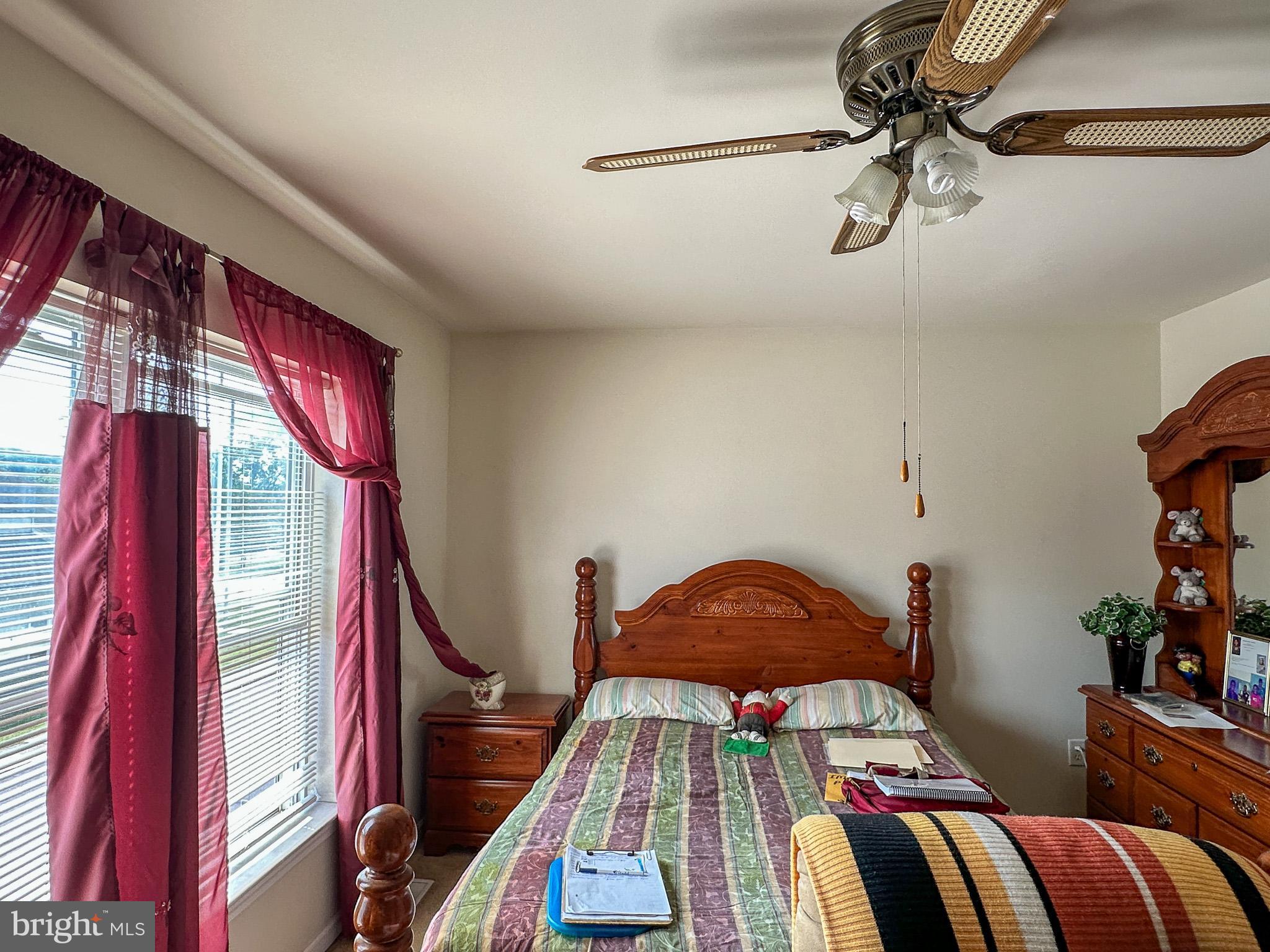 901 Merchant Street Coatesville, PA 19320 - Photo 22 of 36 a bedroom with a bed and ceiling fan