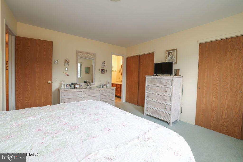 3B Alpine Road, Unit B Manchester Township, NJ 08759 - Photo 5 of 5 a large bedroom with a bed and a flat screen tv