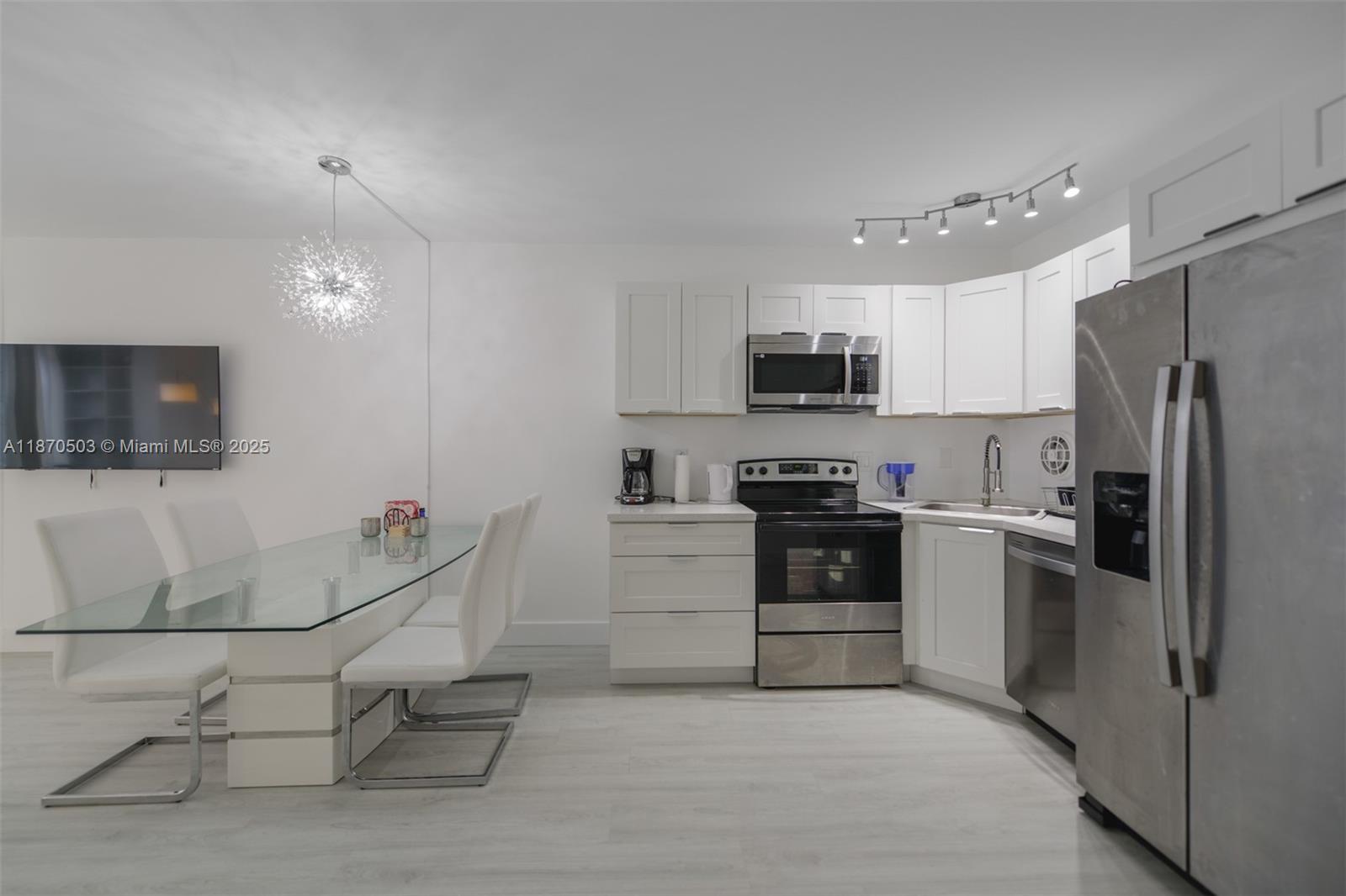 1936 South Ocean Drive, Unit 3C Hallandale Beach, FL 33009 - Photo 3 of 23 a kitchen with granite countertop a refrigerator and a stove top oven