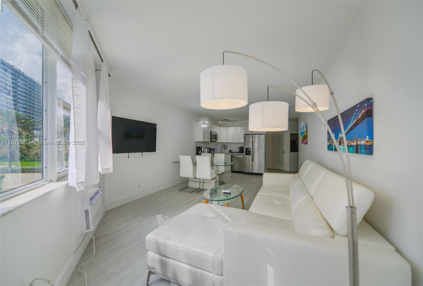 1936 South Ocean Drive, Unit 3C Hallandale Beach, FL 33009 - Photo 4 of 23 a living room with furniture a flat screen tv and a large window