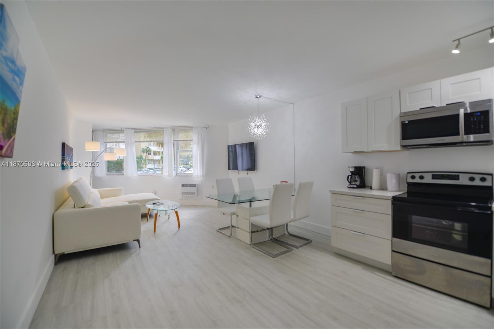 1936 South Ocean Drive, Unit 3C Hallandale Beach, FL 33009 - Photo 6 of 23 a living room with furniture a flat screen tv and a fireplace