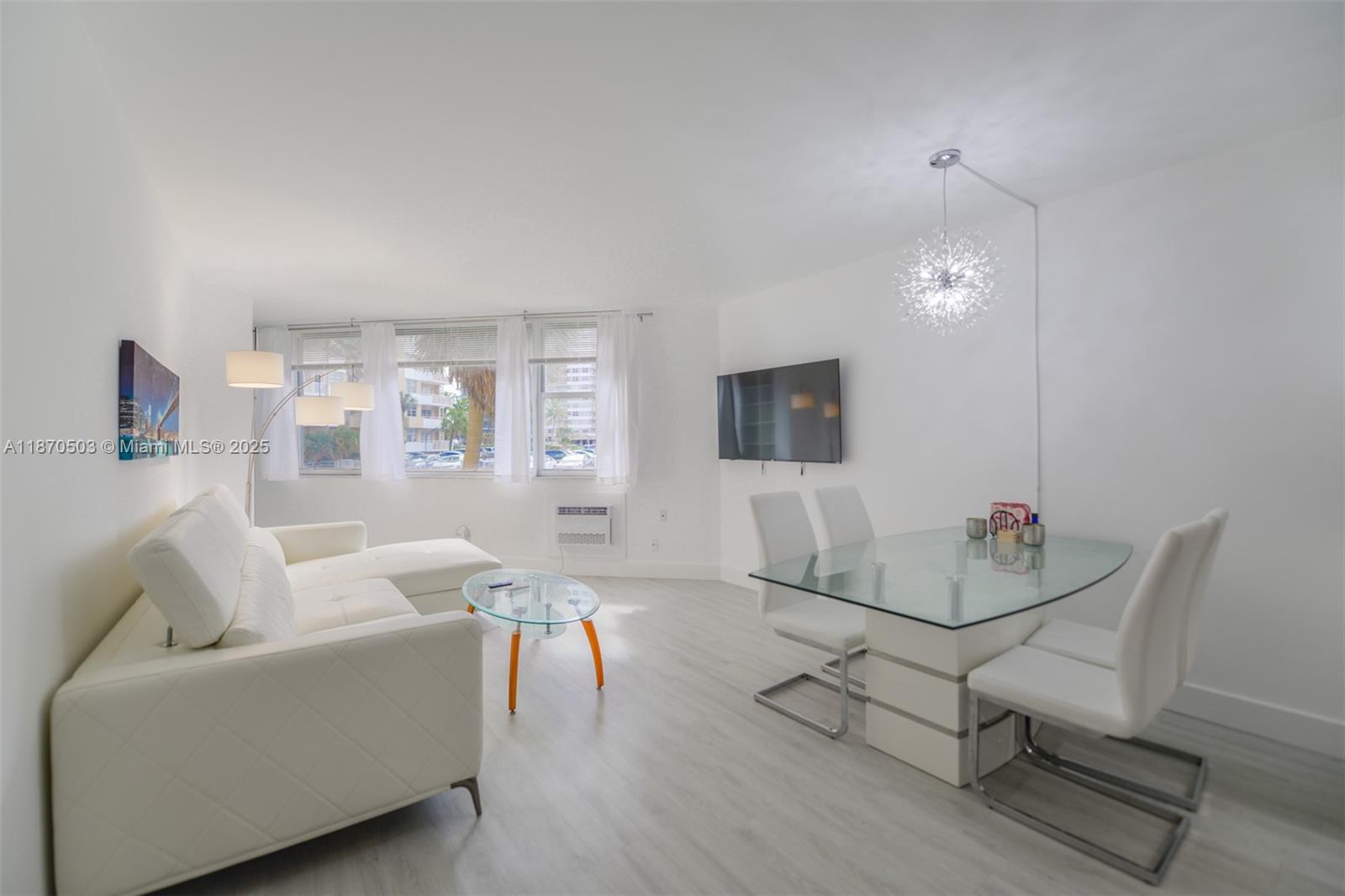 1936 South Ocean Drive, Unit 3C Hallandale Beach, FL 33009 - Photo 8 of 23 a living room with furniture and a flat screen tv