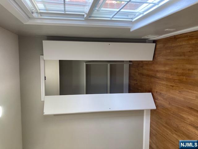 1288 Teaneck Road, Unit 3 Teaneck, NJ 07666 - Photo 11 of 17 a view of an empty room with wooden floor and a window